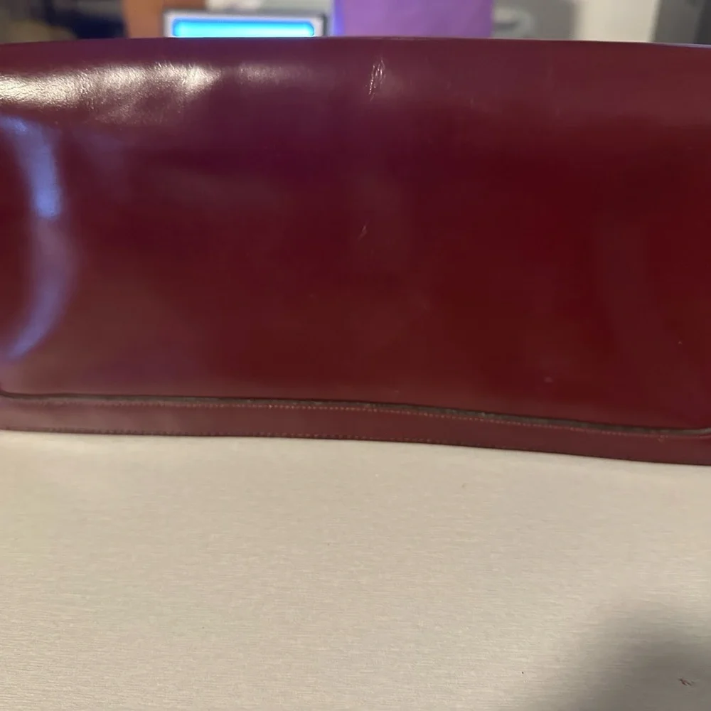 Burgundy Leather Wristlet Clutch with Gold Script Emblem